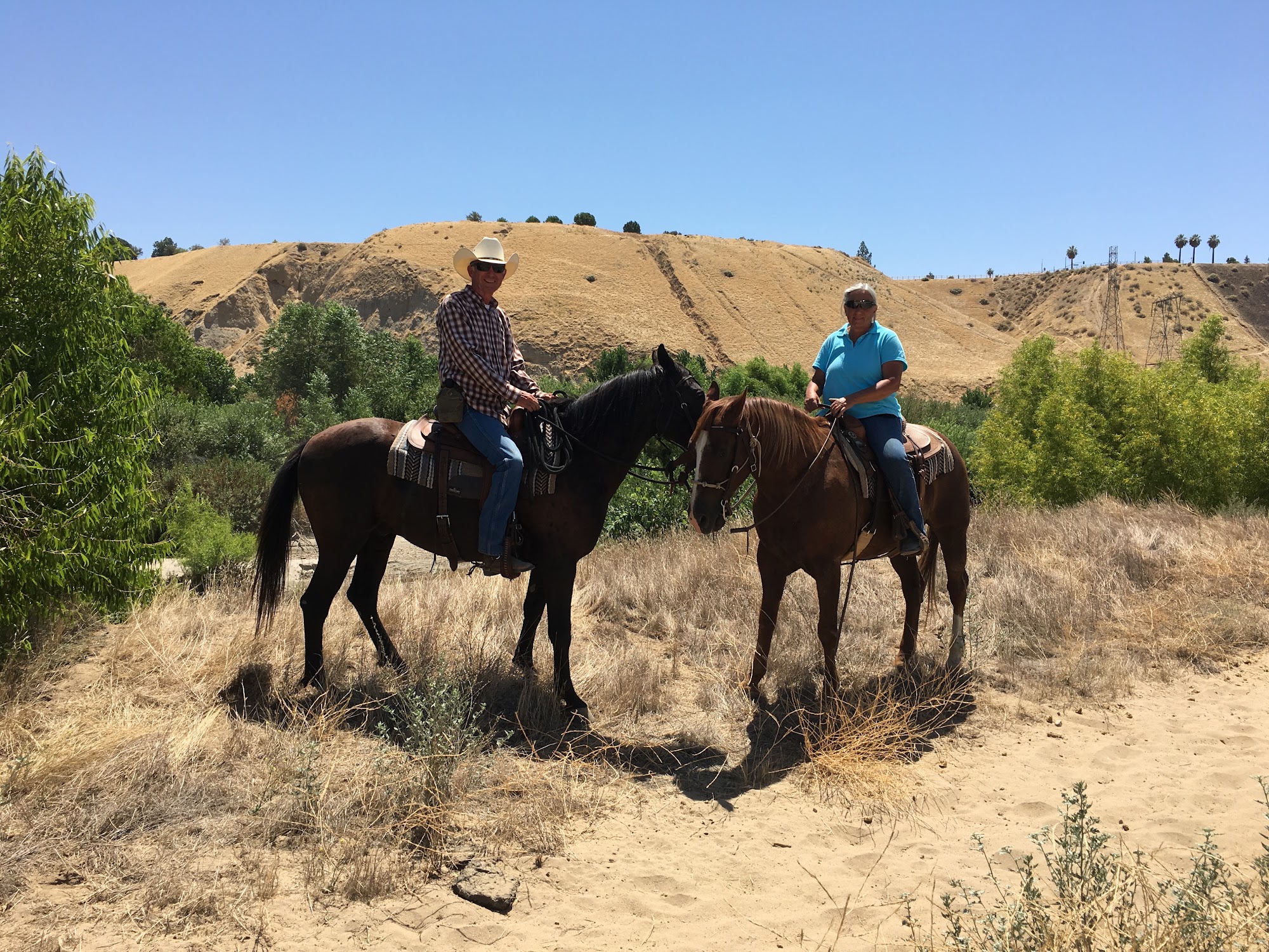 John and Ranae on horseback on the trail